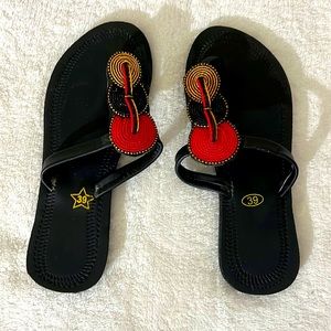 Black slippers with red and golden accents that works with any outfit